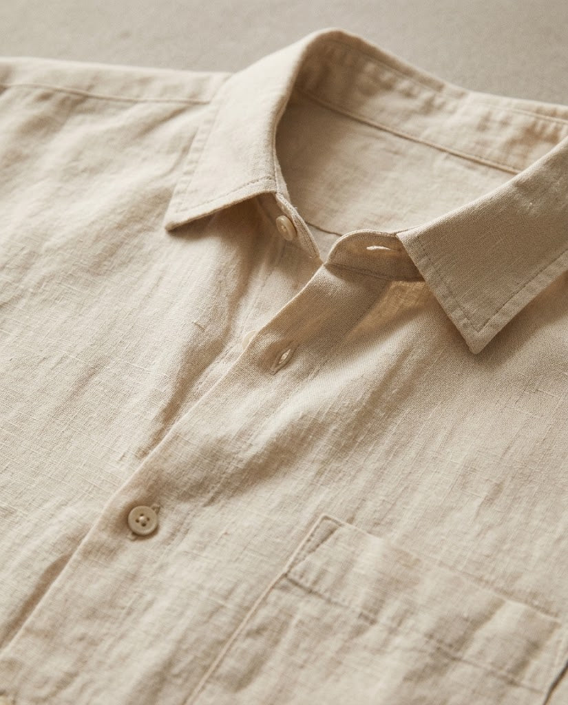Close-up of beige linen shirt collar and buttons