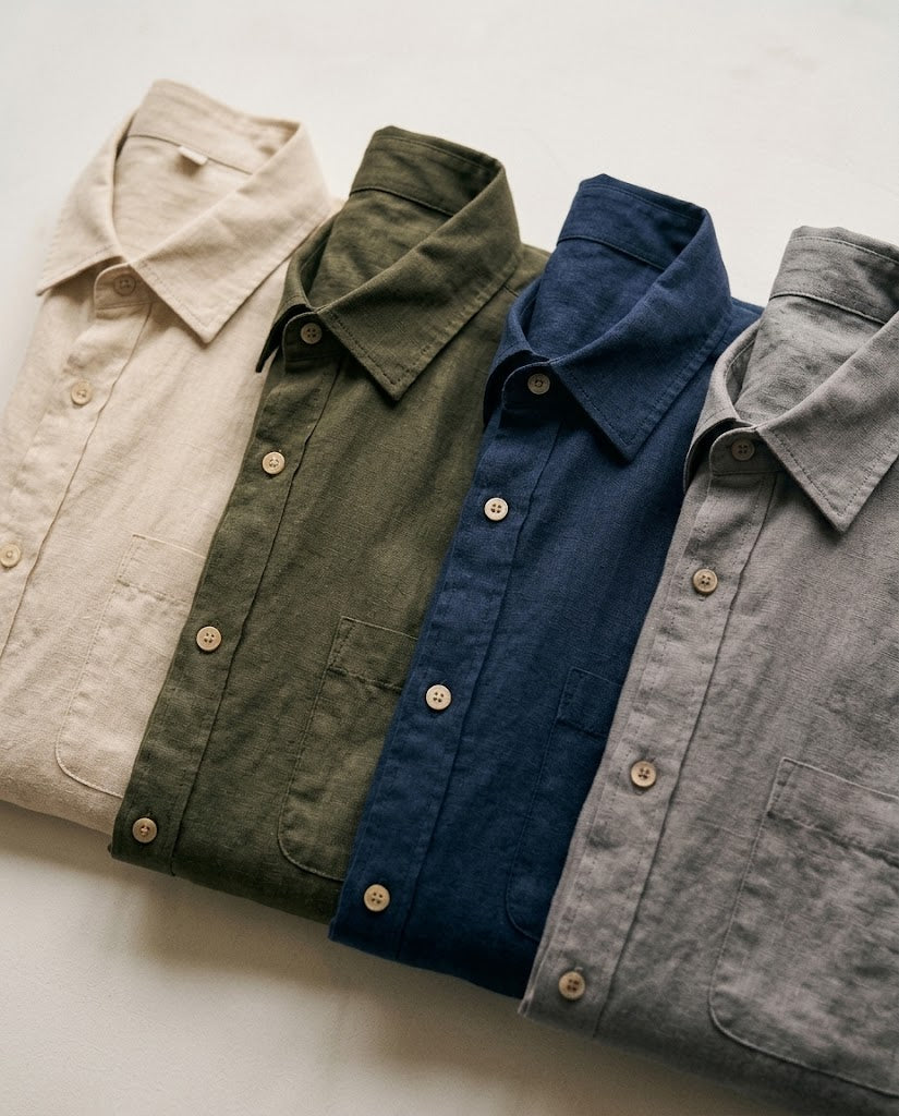 Linen shirts folded in beige, green, navy and grey